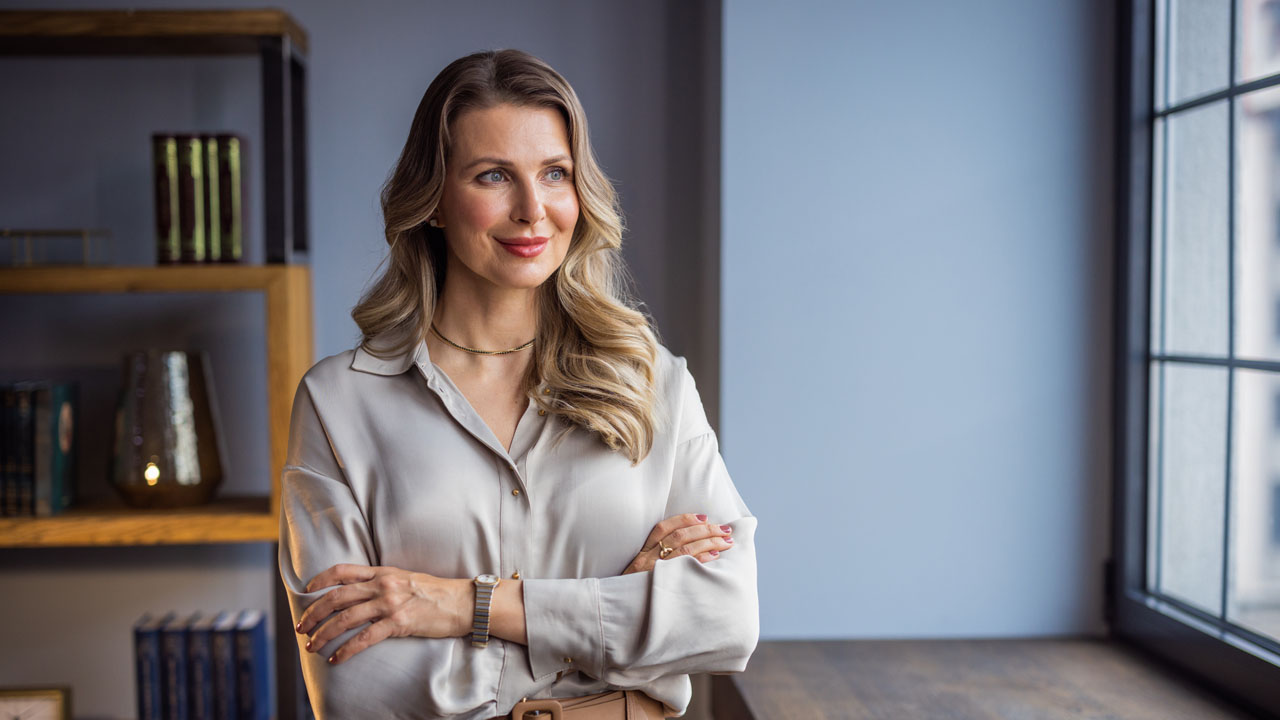 Woman standing looking through the window